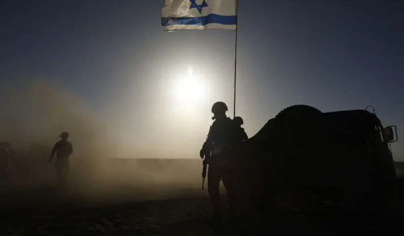 SOUTHERN ISRAEL - MARCH 4: Soldiers with the Israel Defense Forces stand near a military vehicle on March 4, 2024 in southern Israel near the border with Gaza. Over the weekend, the U.S. vice president voiced the most forceful demand yet that there be an immediate ceasefire in the conflict, imploring Hamas to agree to the a six-week pause in fighting and calling on Israel to increase the flow of aid into the territory. (Photo by Amir Levy/Getty Images)