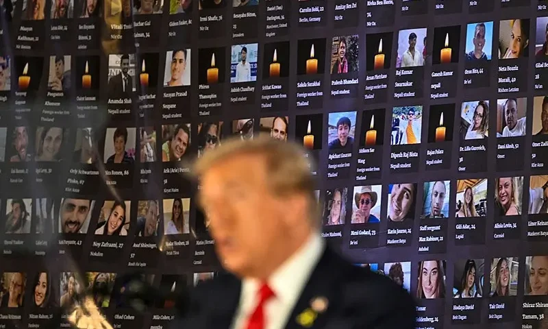 TOPSHOT - Pictures of hostages and victims are seen as former US President and Republican presidential candidate Donald Trump speaks during a remembrance event to mark the first anniversary of the Hamas attack on Israel at Trump National Doral golf club in Miami, Florida, on October 7, 2024. (Photo by CHANDAN KHANNA / AFP) (Photo by CHANDAN KHANNA/AFP via Getty Images)
