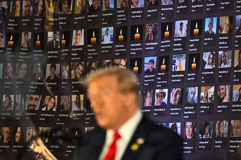 TOPSHOT - Pictures of hostages and victims are seen as former US President and Republican presidential candidate Donald Trump speaks during a remembrance event to mark the first anniversary of the Hamas attack on Israel at Trump National Doral golf club in Miami, Florida, on October 7, 2024. (Photo by CHANDAN KHANNA / AFP) (Photo by CHANDAN KHANNA/AFP via Getty Images)