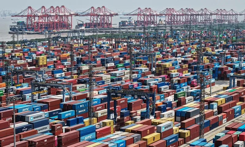 TOPSHOT - An aerial view shows cargo containers stacked at a port in Shanghai on April 20, 2025. (Photo by AFP) / China OUT (Photo by STR/AFP via Getty Images)