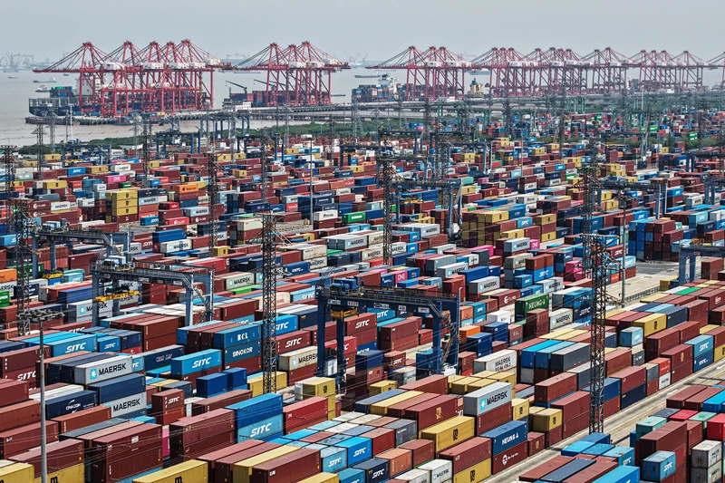 TOPSHOT - An aerial view shows cargo containers stacked at a port in Shanghai on April 20, 2025. (Photo by AFP) / China OUT (Photo by STR/AFP via Getty Images)