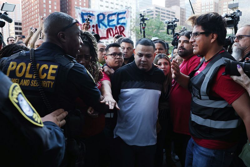 BALTIMORE, MARYLAND - AUGUST 25: Surrounded by reporters, Kilmar Abrego Garcia and his wife Jennifer Vasquez Sura enter a U.S. Immigration and Customs Enforcement (ICE) field office on August 25, 2025 in Baltimore, Maryland. The U.S. Government is threatening to deport Garcia, a Maryland construction worker from El Salvador, to Uganda after he rejected a plea deal to be charged with Human Smuggling and deported to Costa Rica. Earlier this year Garcia was wrongfully deported to a notorious anti-terrorism prison CECOT in El Salvador. (Photo by Anna Moneymaker/Getty Images)