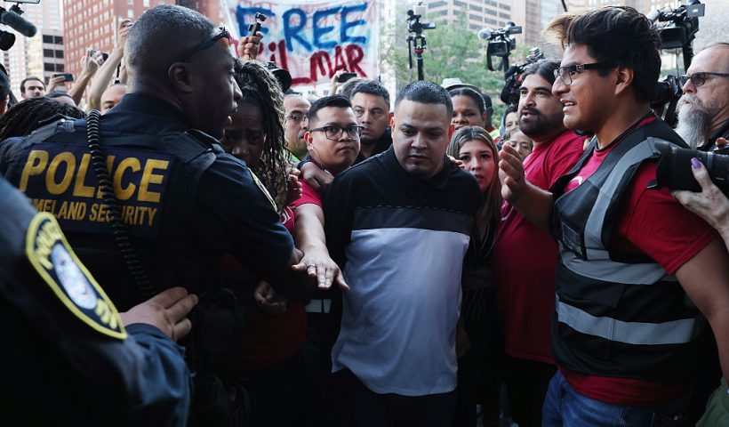 BALTIMORE, MARYLAND - AUGUST 25: Surrounded by reporters, Kilmar Abrego Garcia and his wife Jennifer Vasquez Sura enter a U.S. Immigration and Customs Enforcement (ICE) field office on August 25, 2025 in Baltimore, Maryland. The U.S. Government is threatening to deport Garcia, a Maryland construction worker from El Salvador, to Uganda after he rejected a plea deal to be charged with Human Smuggling and deported to Costa Rica. Earlier this year Garcia was wrongfully deported to a notorious anti-terrorism prison CECOT in El Salvador. (Photo by Anna Moneymaker/Getty Images)