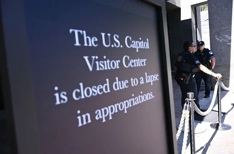 US Capitol police officers stand behind a roped-off area with a sign announcing the closure of the visitor center on the first day of the US government shutdown in Washington, DC, on October 1, 2025. Efforts to bring a quick end to the US government shutdown floundered Wednesday when senators rejected a plan to resolve an acrimonious funding stand-off between President Donald Trump and Democrats in Congress. With the government out of money after Trump and lawmakers failed to agree on a deal to keep the lights on, many federal departments and agencies have been closed since midnight. (Photo by Brendan SMIALOWSKI / AFP) (Photo by BRENDAN SMIALOWSKI/AFP via Getty Images)