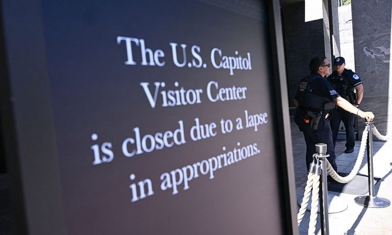 US Capitol police officers stand behind a roped-off area with a sign announcing the closure of the visitor center on the first day of the US government shutdown in Washington, DC, on October 1, 2025. Efforts to bring a quick end to the US government shutdown floundered Wednesday when senators rejected a plan to resolve an acrimonious funding stand-off between President Donald Trump and Democrats in Congress. With the government out of money after Trump and lawmakers failed to agree on a deal to keep the lights on, many federal departments and agencies have been closed since midnight. (Photo by Brendan SMIALOWSKI / AFP) (Photo by BRENDAN SMIALOWSKI/AFP via Getty Images)