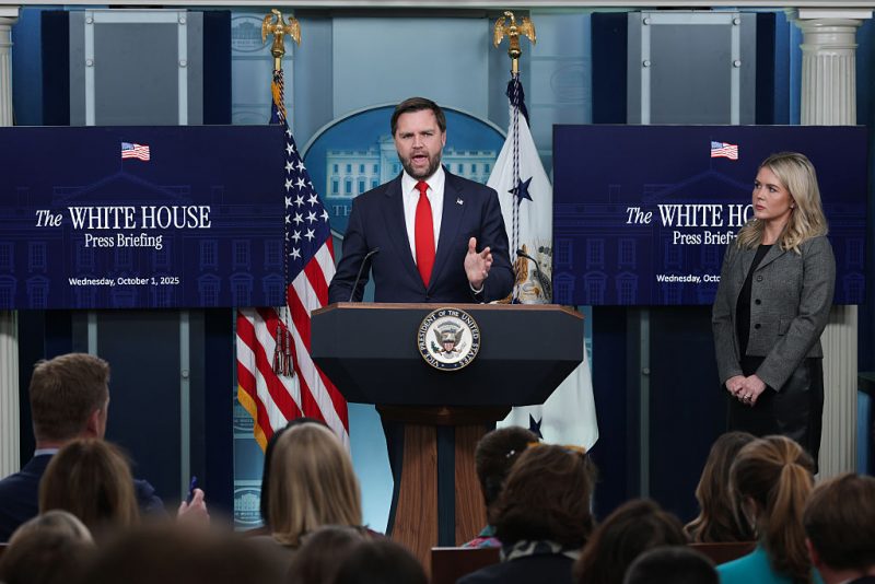WASHINGTON, DC - OCTOBER 01: U.S. Vice President JD Vance speaks as White House Press Secretary Karoline Leavitt (R) looks on during the daily press briefing in the Brady Press Briefing Room at the White House on October 01, 2025 in Washington, DC. Vance joined Leavitt to discuss the federal government shutdown, after Congress and the White House failed to reach a funding deal by the October 1 deadline and halted U.S. government services for the first time in nearly seven years. (Photo by Alex Wong/Getty Images)