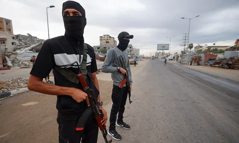 Members of the internal security forces loyal to the Palestinian group Hamas, man a checkpoint in the Nuseirat refugee camp in the central Gaza Strip, on October 12, 2025. Israel declared a ceasefire in Gaza and began to pull back its forces on October 10, as tens of thousands of exhausted Palestinians made their way back to their devastated homes. (Photo by Eyad BABA / AFP) (Photo by EYAD BABA/AFP via Getty Images)