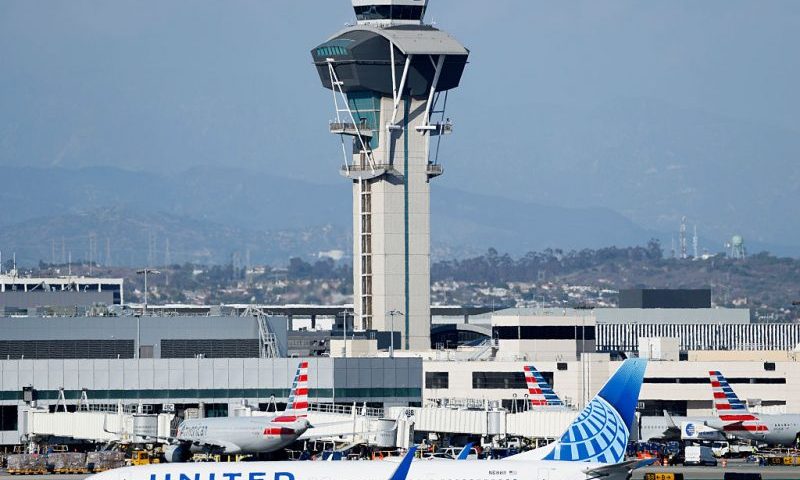 LOS ANGELES, CALIFORNIA - OCTOBER 22: A United plane taxis in front of the air traffic control tower at Los Angeles International Airport on October 22, 2025 in Los Angeles, California. The Secretary of Transportation stated yesterday that air traffic controllers could stop receiving a paycheck next week while the federal government shutdown continues. (Photo by Mario Tama/Getty Images)