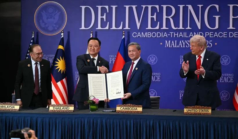 US President Donald Trump (R) claps as Thailand's Prime Minister Anutin Charnvirakul (2nd L) shakes hands with Cambodia's Prime Minister Hun Manet (2nd R) as Malaysia's Prime Minister Anwar Ibrahim during a ceremonial signing of a ceasefire agreement between Cambodia and Thailand on the sidelines of the 47th Association of Southeast Asian Nations (ASEAN) Summit in Kuala Lumpur on October 26, 2025. (Photo by ANDREW CABALLERO-REYNOLDS / AFP) (Photo by ANDREW CABALLERO-REYNOLDS/AFP via Getty Images)