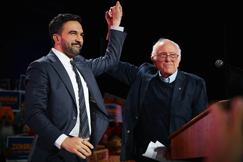 NEW YORK, NEW YORK - OCTOBER 26: New York Mayoral Candidate Zohran Mamdani celebrates with Sen. Bernie Sanders (I-VT) during an election rally with Sanders and U.S. Rep. Alexandria Ocasio-Cortez (D-NY) at Forest Hills Stadium on October 26, 2025 in the Queens borough of New York City. The mayoral election will take place on November 4, 2025. (Photo by Andres Kudacki/Getty Images)