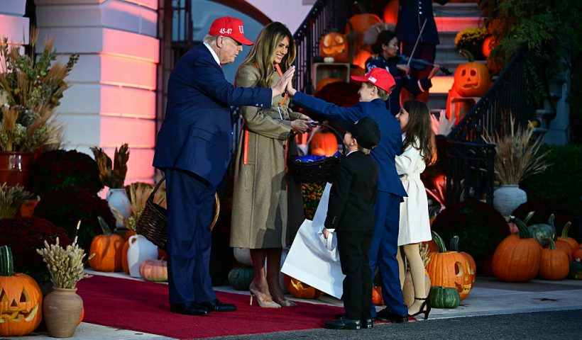 US President Donald Trump high-fives a boy as he and First Lady Melania Trump host a Halloween event at the White House in Washington, DC, on OCtober 30, 2025. (Photo by Jim WATSON / AFP) (Photo by JIM WATSON/AFP via Getty Images)