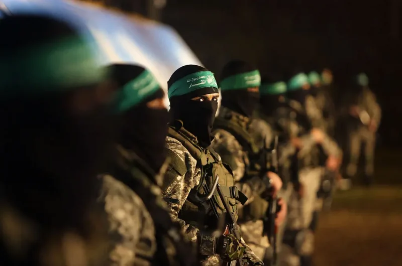 TOPSHOT - Palestinian members of the Ezzedine al-Qassam Brigades, the armed wing of the Hamas movement, take part in a gathering on January 31, 2016 in Gaza city to pay tribute to their fellow militants who died after a tunnel collapsed in the Gaza Strip. Seven Hamas militants were killed on January 28, 2016 after a tunnel built for fighting Israel collapsed in the Gaza Strip, highlighting concerns that yet another conflict could eventually erupt in the Palestinian enclave. (Photo by MAHMUD HAMS / AFP) (Photo by MAHMUD HAMS/AFP via Getty Images)
