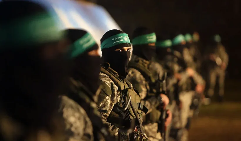 TOPSHOT - Palestinian members of the Ezzedine al-Qassam Brigades, the armed wing of the Hamas movement, take part in a gathering on January 31, 2016 in Gaza city to pay tribute to their fellow militants who died after a tunnel collapsed in the Gaza Strip. Seven Hamas militants were killed on January 28, 2016 after a tunnel built for fighting Israel collapsed in the Gaza Strip, highlighting concerns that yet another conflict could eventually erupt in the Palestinian enclave. (Photo by MAHMUD HAMS / AFP) (Photo by MAHMUD HAMS/AFP via Getty Images)