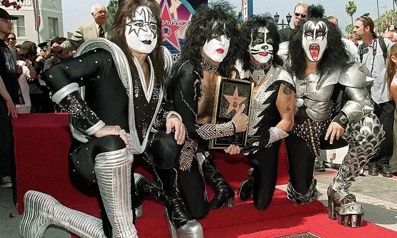 HOLLYWOOD, : Members of the rock band Kiss (from left to right): Ace Frehley, Paul Stanley, Peter Criss and Gene Simmons pose by the star they received during a Hollywood Walk of Fame ceremony 11 August 1999 in Hollywood, Ca. The group, known for their theatrical stage performances, has sold 80 million records over their 26 year career. AFP PHOTO/Vince BUCCI (Photo credit should read Vince Bucci/AFP via Getty Images)