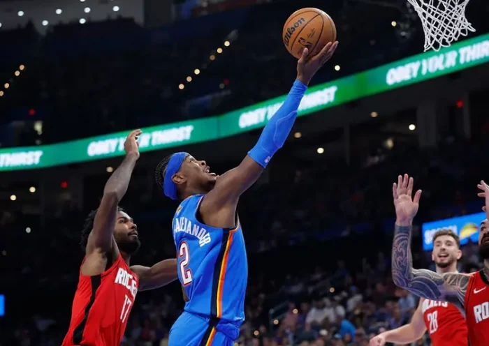 Oklahoma City Thunder guard Shai Gilgeous-Alexander (2) goes up for a basket between Houston Rockets forward Tari Eason (17) and center Steven Adams (12) during the first half at Paycom Center. Mandatory Credit: Alonzo Adams-Imagn Images