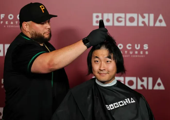 A fan gets his head shaved for a free preview of Yorgos Lanthimos’s new film 'Bugonia', in Culver City, California, U.S., October 20, 2025. REUTERS/Daniel Cole