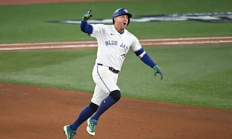 Toronto Blue Jays right fielder George Springer (4) celebrates as he runs the bases after hitting a three run home run against the Seattle Mariners in the seventh inning during game seven of the ALCS round for the 2025 MLB playoffs at Rogers Centre. Mandatory Credit: Dan Hamilton-Imagn Images