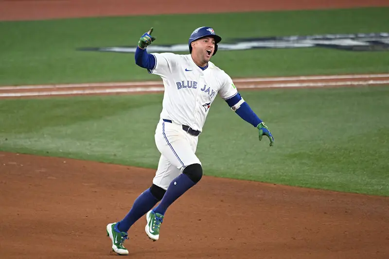 Toronto Blue Jays right fielder George Springer (4) celebrates as he runs the bases after hitting a three run home run against the Seattle Mariners in the seventh inning during game seven of the ALCS round for the 2025 MLB playoffs at Rogers Centre. Mandatory Credit: Dan Hamilton-Imagn Images