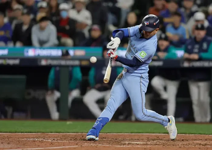 Toronto Blue Jays second baseman Andres Gimenez (0) singles in the seventh inning against the Seattle Mariners during game three of the ALCS round for the 2025 MLB playoffs at T-Mobile Park. Mandatory Credit: John Froschauer-Imagn Images