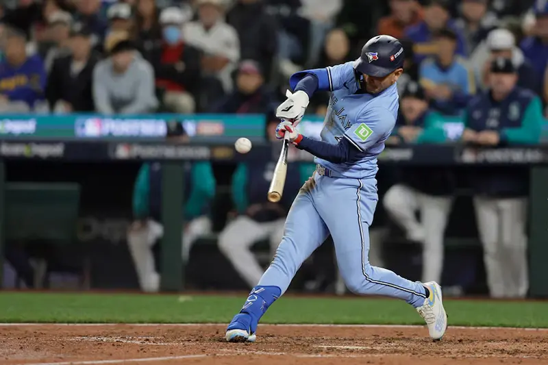 Toronto Blue Jays second baseman Andres Gimenez (0) singles in the seventh inning against the Seattle Mariners during game three of the ALCS round for the 2025 MLB playoffs at T-Mobile Park. Mandatory Credit: John Froschauer-Imagn Images