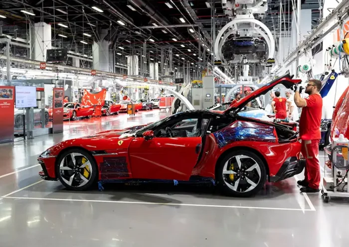 A Ferrari worker inspects a car inside the company's factory in Maranello, Italy, October 2, 2025. REUTERS/Remo Casilli/File Photo