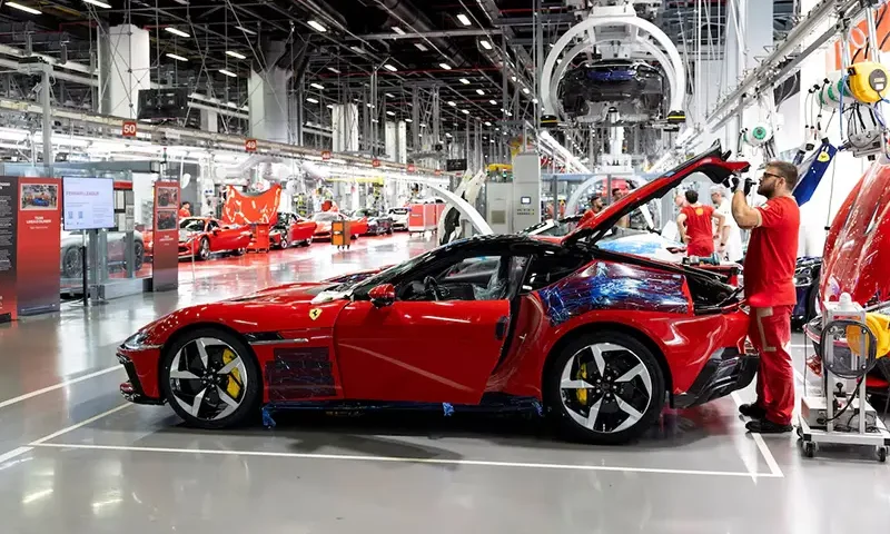A Ferrari worker inspects a car inside the company's factory in Maranello, Italy, October 2, 2025. REUTERS/Remo Casilli/File Photo