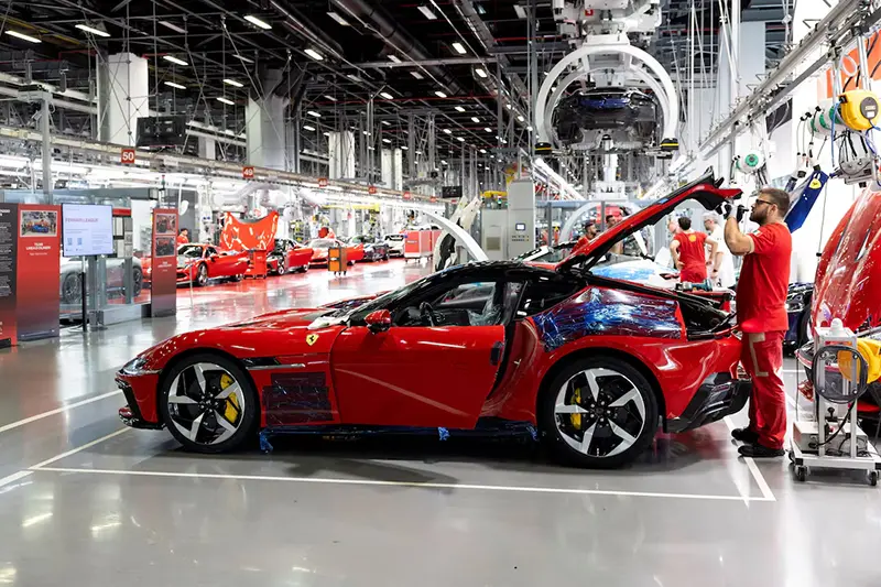 A Ferrari worker inspects a car inside the company's factory in Maranello, Italy, October 2, 2025. REUTERS/Remo Casilli/File Photo