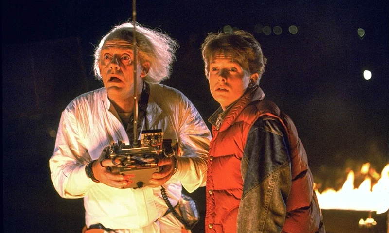 This image released by Universal Pictures shows Christopher Lloyd, left, and Michael J. Fox in a scene from the 1985 film “Back to the Future.” (Universal Pictures via AP)
