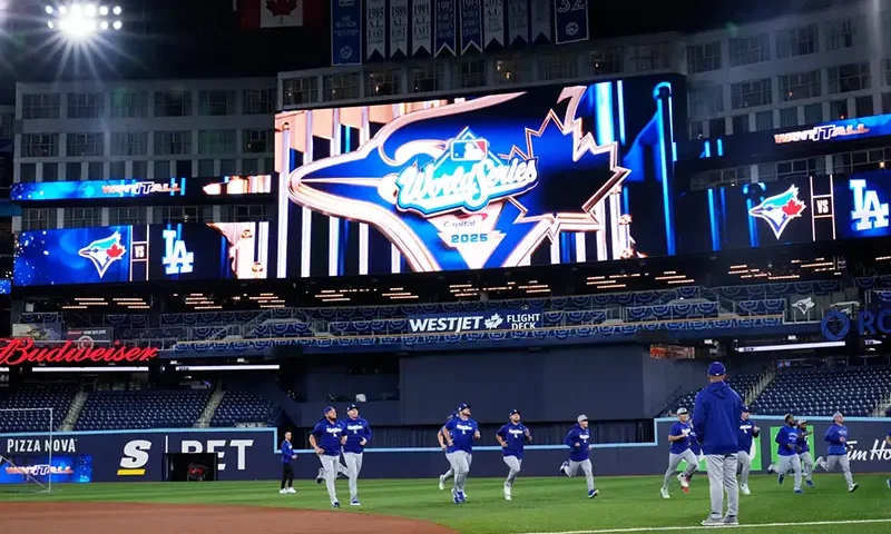 Members of the Los Angeles Dodgers warn up during a World Series baseball media day, Thursday, Oct. 23, 2025, in Toronto. The Toronto Blue Jays face the Los Angeles Dodgers in Game 1 on Friday. (AP Photo/Brynn Anderson)