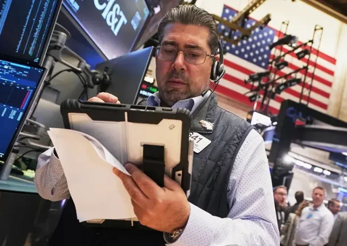 Trader Michael Capolino works on the floor of the New York Stock Exchange, Wednesday, Oct. 15, 2025. (AP Photo/Richard Drew)