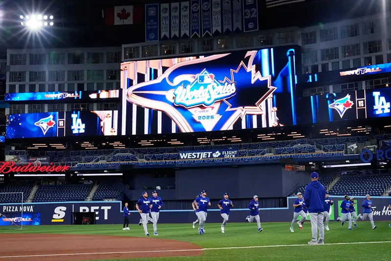 Members of the Los Angeles Dodgers warn up during a World Series baseball media day, Thursday, Oct. 23, 2025, in Toronto. The Toronto Blue Jays face the Los Angeles Dodgers in Game 1 on Friday. (AP Photo/Brynn Anderson)