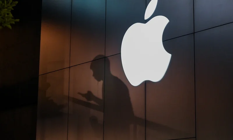 The shadow of a man is cast on the wall of an Apple store as he uses his mobile phone in Beijing on August 26, 2019. There were signs of a thaw in frosty trade-war tensions between China and the US on August 26 as President Donald Trump said delegations would "very shortly" resume talks and Beijing's top negotiator called for "calm". (Photo by GREG BAKER / AFP) (Photo by GREG BAKER/AFP via Getty Images)