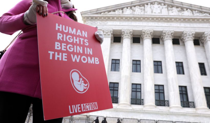 WASHINGTON, DC - JANUARY 29: A pro-life activist holds a sign outside the U.S. Supreme Court during the 48th annual March for Life January 29, 2021 in Washington, DC. Due to the COVID-19 pandemic, a much smaller group of activists participated in the annual march that marked the 1973 Roe v. Wade ruling by the U.S. Supreme Court that had legalized abortion. (Photo by Alex Wong/Getty Images)