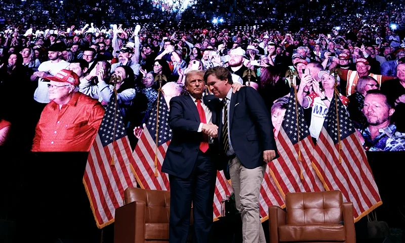 PHOENIX, ARIZONA - OCTOBER 31: Republican presidential nominee, former President Donald Trump shakes hands with Tucker Carlson at the conclusion of a conversation during Carlson's Live Tour at the Desert Diamond Arena on October 31, 2024 in Phoenix, Arizona. With less than a week until Election Day, Trump is campaigning for re-election in New Mexico and the battleground states of Nevada and Arizona on Thursday. (Photo by Chip Somodevilla/Getty Images)