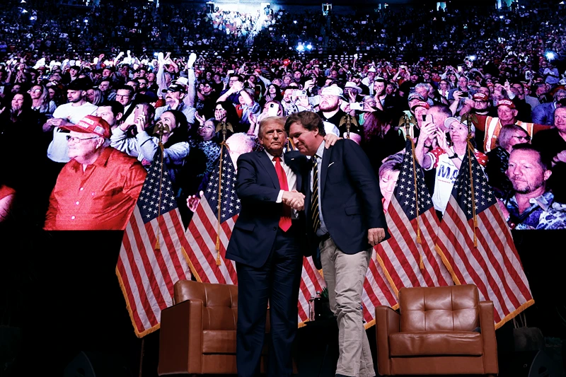 PHOENIX, ARIZONA - OCTOBER 31: Republican presidential nominee, former President Donald Trump shakes hands with Tucker Carlson at the conclusion of a conversation during Carlson's Live Tour at the Desert Diamond Arena on October 31, 2024 in Phoenix, Arizona. With less than a week until Election Day, Trump is campaigning for re-election in New Mexico and the battleground states of Nevada and Arizona on Thursday. (Photo by Chip Somodevilla/Getty Images)