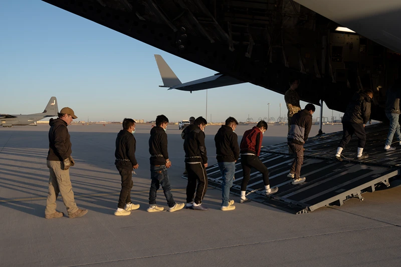 FORT BLISS, TX - JANUARY 23, 2025: (EDITOR'S NOTE: This Handout image was provided by a third-party organization and may not adhere to Getty Images' editorial policy.) In this handout provided by the U.S. Department of Defense, U.S. Customs and Border Protection security agents guide illegal immigrants onboard a C-17 Globemaster III assigned to the 60th Air Mobility Wing for a removal flight at Fort Bliss, Texas, on Jan. 23, 2025. Under the direction of U.S. Northern Command, U.S. Transportation Command is supporting Immigration and Customs Enforcement removal flights by providing military airlift. (Dept. of Defense photo by U.S. Army Sgt. 1st Class Nicholas J. De La Pena)