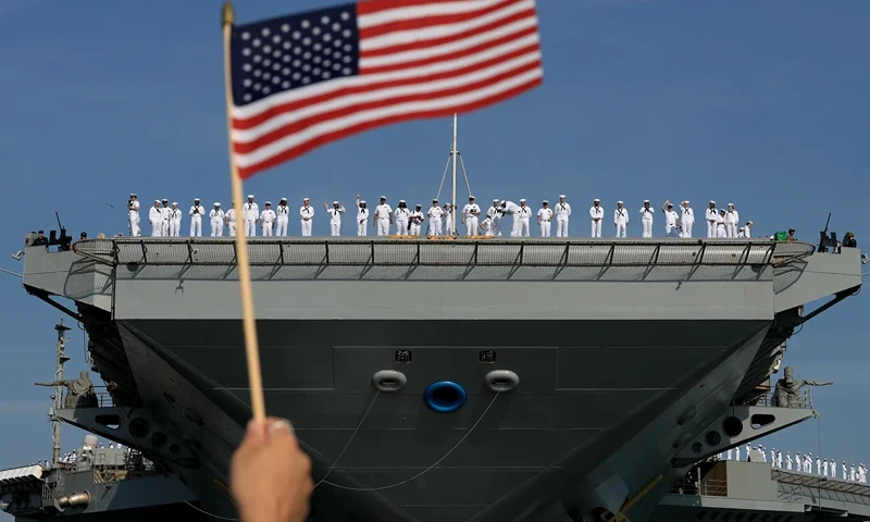 NORFOLK, VIRGINIA - JUNE 24: U.S. Navy sailors stand along the deck as they prepare for the aircraft carrier USS Gerald R. Ford to depart from the Naval Station Norfolk on June 24, 2025, in Norfolk, Virginia. The aircraft carrier is leaving on its scheduled deployment to the U.S. European Command area of responsibility. The deployment comes during the ongoing conflict in the Middle East between Israel and Iran. (Photo by Joe Raedle/Getty Images)