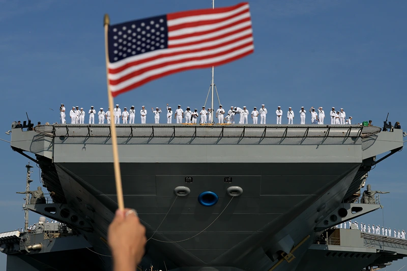 NORFOLK, VIRGINIA - JUNE 24: U.S. Navy sailors stand along the deck as they prepare for the aircraft carrier USS Gerald R. Ford to depart from the Naval Station Norfolk on June 24, 2025, in Norfolk, Virginia. The aircraft carrier is leaving on its scheduled deployment to the U.S. European Command area of responsibility. The deployment comes during the ongoing conflict in the Middle East between Israel and Iran. (Photo by Joe Raedle/Getty Images)