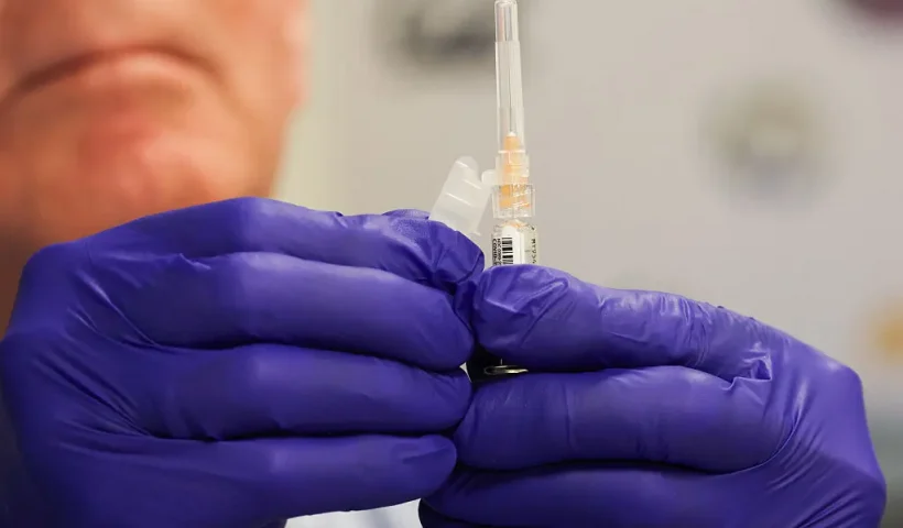 pharmacist prepares a shot of the Pfizer-BioNTech Covid-19 vaccine during an immunization event at the L.A. Care and Blue Shield of California Promise Health Plan Community Resource Center in the Panorama City neighborhood of Los Angeles, California, on October 24, 2025. (Photo by Patrick T. Fallon / AFP) (Photo by PATRICK T. FALLON/AFP via Getty Images)