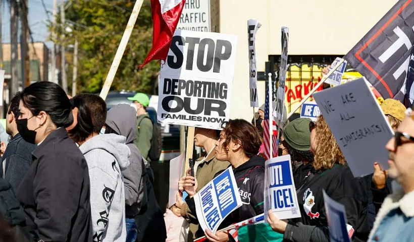 Protesters hold signs against Immigration and Customs Enforcement during the "ICE and DHS Out of Little Village" demonstration at the predominantly Mexican-American neighborhood of Little Village, also known as "La Villita", in Chicago, Illinois on October 25, 2025. US President Donald Trump's administration has asked the Supreme Court to lift lower court rulings blocking his deployment of the National Guard in Chicago. Trump has ordered hundreds of National Guard troops to Chicago, claiming they are needed to combat crime and to protect immigration agents and facilities in America's third-largest city. (Photo by KAMIL KRZACZYNSKI / AFP) (Photo by KAMIL KRZACZYNSKI/AFP via Getty Images)