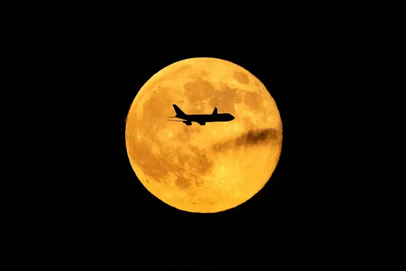 LOUISVILLE, KENTUCKY - NOVEMBER 5: A plane passes in front of the Beaver supermoon at Louisville Muhammad Ali International Airport on November 05, 2025 in Louisville, Kentucky. Twelve people were killed and a shelter-in-place order was instituted after a fully fueled UPS cargo plane crashed shortly after takeoff near the airport. (Photo by Michael Swensen/Getty Images)