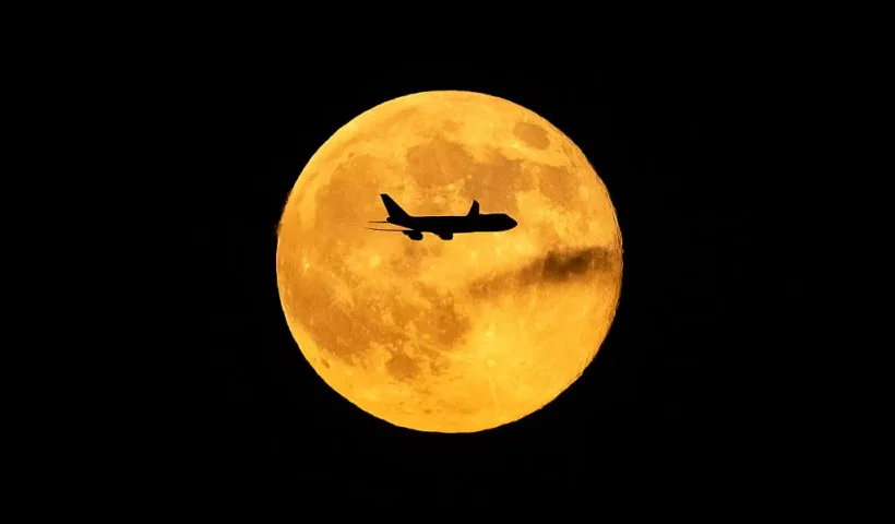 LOUISVILLE, KENTUCKY - NOVEMBER 5: A plane passes in front of the Beaver supermoon at Louisville Muhammad Ali International Airport on November 05, 2025 in Louisville, Kentucky. Twelve people were killed and a shelter-in-place order was instituted after a fully fueled UPS cargo plane crashed shortly after takeoff near the airport. (Photo by Michael Swensen/Getty Images)