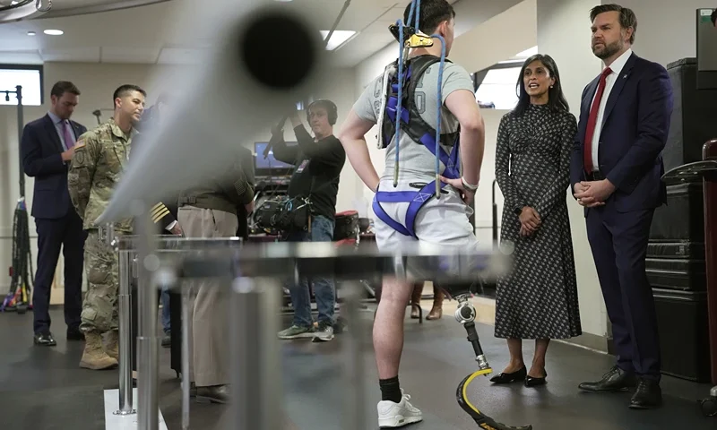 BETHESDA, MARYLAND - NOVEMBER 10: U.S. Vice President JD Vance (R) and second lady Usha Vance talk with Coast Guard Seaman Sam Kenyon as he undergoes therapy while they visit the Military Advanced Training Center (MATC) at Walter Reed National Military Medical Center on November 10, 2025 in Bethesda, Maryland. Vance met members of the military the day before Veterans Day, the nation’s holiday to honor those who have served in the U.S. military. (Photo by Andrew Harnik/Getty Images)