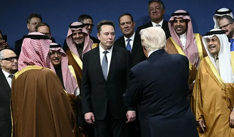 US President Donald Trump, Saudi Crown Prince, Prime Minister Mohammed bin Salman, Elon Musk (C) and other attendees, arrive for a family picture the US-Saudi Investment Forum at the John F. Kennedy Center for the Performing Arts in Washington, DC on November 19, 2025. (Photo by Brendan SMIALOWSKI / AFP) (Photo by BRENDAN SMIALOWSKI/AFP via Getty Images)