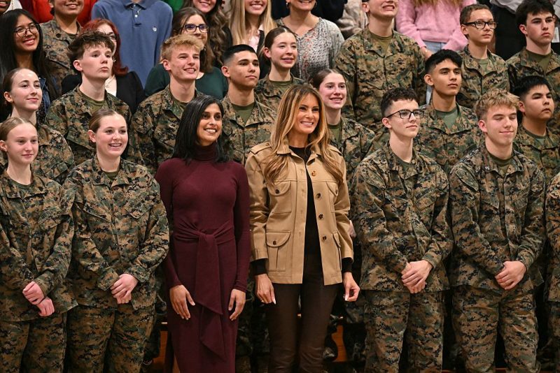 US First Lady Melania Trump and Second Lady Usha Vance (L) pose for a picture with students at Lejeune High School at Marine Corps Base Camp Lejeune in Jacksonville, North Carolina, November 19, 2025, as they travel together to visit military families. (Photo by SAUL LOEB / AFP) (Photo by SAUL LOEB/AFP via Getty Images)