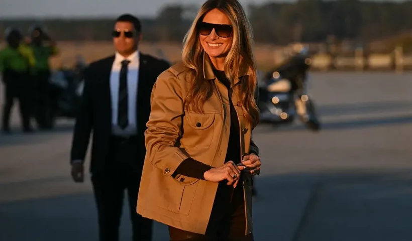 US First Lady Melania Trump smiles as she boards the plane to depart from Albert J. Ellis Airport in Jacksonville, North Carolina, November 19, 2025. First Lady Melania Trump and Second Lady Usha Vance are returning to Washington after visiting military families at Marine Corps Air Station New River in Jacksonville, North Carolina. (Photo by SAUL LOEB / AFP) (Photo by SAUL LOEB/AFP via Getty Images)
