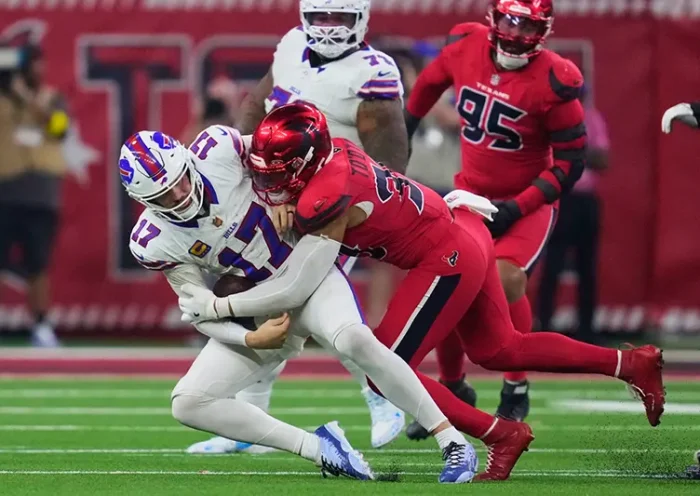 Buffalo Bills quarterback Josh Allen (17) is sacked by Houston Texans linebacker Henry To’oTo’o (39) in the second half of an NFL football game Thursday, Nov. 20, 2025, in Houston. (AP Photo/Ashley Landis)