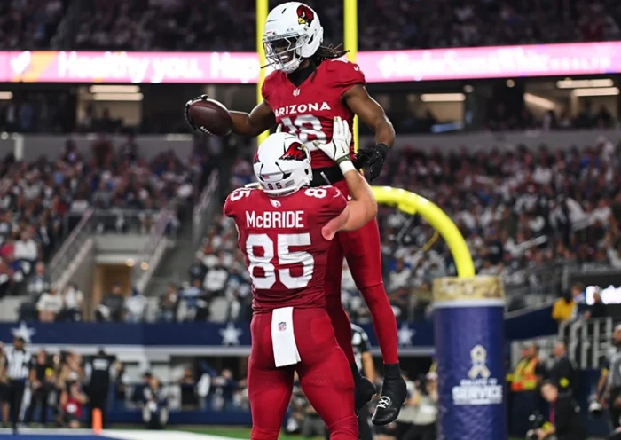 Arizona Cardinals’ Marvin Harrison Jr. (18) and Trey McBride (85) celebrate Harrison Jr.s’ touchdown catch in the first half of an NFL football game against the Dallas Cowboys Monday, Nov. 3, 2025, in Arlington, Texas. (AP Photo/Jessica Tobias)