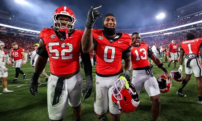 Georgia defensive lineman Christen Miller (52) and linebacker Gabe Harris Jr. (0) react after an NCAA college football game against Texas, Saturday, Nov. 15, 2025, in Athens, Ga. (AP Photo/Colin Hubbard)