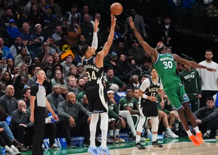 Milwaukee Bucks forward Giannis Antetokounmpo (34) shoots a three-pointer against Dallas Mavericks center Moussa Cisse (30) during the second half of an NBA basketball game in Dallas, Monday, Nov. 10, 2025. (AP Photo/LM Otero)